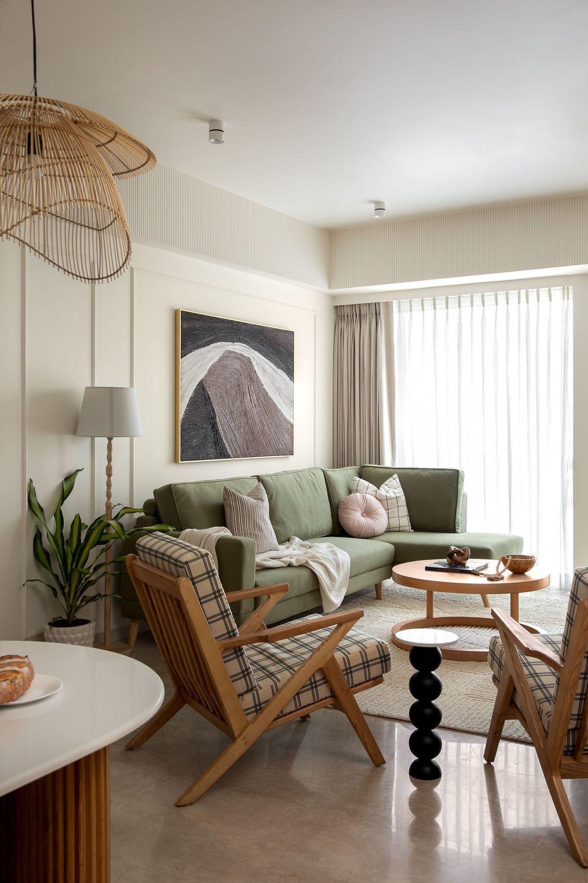 Living room with a blue leaf mural wall and a modular grey sofa